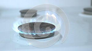 The gas turns on, a blue flame appears. Energy resource gas heating. Gas stove on a white background. Sanctions against