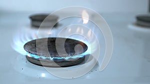 The gas turns on, a blue flame appears. Energy resource gas heating. Gas stove on a white background. Sanctions against