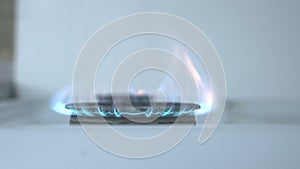 The gas turns on, a blue flame appears. Energy resource gas heating. Gas stove on a white background. Sanctions against