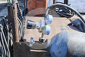 Gas welding equipment. A cylinder with propane and a cylinder with oxygen