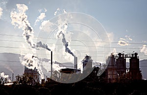 Gases steam and smoke coming from industrial site photo