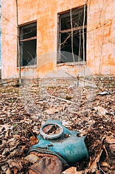 Gasmask Near Abandoned Ruined Old Village School Building In Chernobyl Resettlement Zone. Belarus. Chornobyl Catastrophe