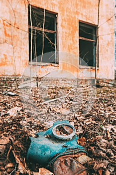 Gasmask Near Abandoned Ruined Old Village School Building In Chernobyl Resettlement Zone. Belarus. Chornobyl Catastrophe