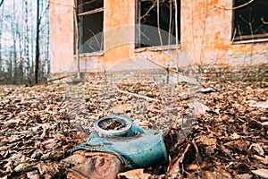 Gasmask Near Abandoned Ruined Old Village School Building In Chernobyl Resettlement Zone. Belarus. Chornobyl Catastrophe