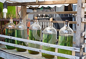 Gasolina in bottles for sale on bali Indonesia, petrol at local station photo