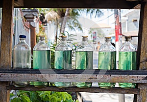 Gasolina in bottles for sale on bali Indonesia, petrol at local station photo