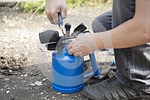 A gasoline blowtorch.Using a gasoline blowtorch for repairs