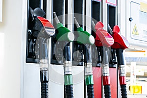 Gasoline and diesel distributor at the gas station. Gas pump nozzles. Petrol filling gun close-up at the gas station. Colorful Pet