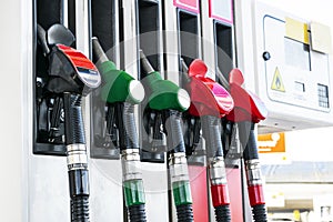 Gasoline and diesel distributor at the gas station. Gas pump nozzles. Petrol filling gun close-up at the gas station. Colorful Pet