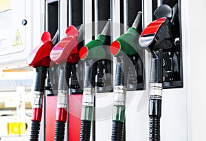 Gasoline and diesel distributor at the gas station. Gas pump nozzles. Petrol filling gun close-up at the gas station. Colorful Pet