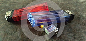 Gasoline lighters on a colorful table