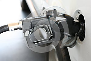 Gasoline nozzle in gas tank photo