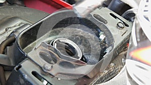 Gasoline pistol is poured into a fuel tank of motorcycle, close up view.