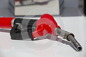 Gasoline pistol pump fuel nozzle Gas station pump. Man refueling gasoline with fuel in a car, holding a nozzle. Limited depth of