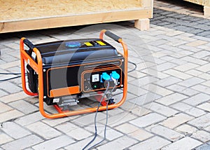 Gasoline Portable Generator on the House Construction Site. Close up on Mobile Backup Generator. Standby Generator