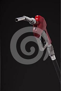 Gasoline pump nozzle with red vinyl covered handle isolated on b