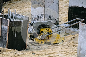 Gasoline soil compaction machine with vibrating plate on building site