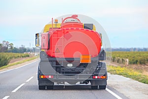 Gasoline tanker moves on a country road. Back view