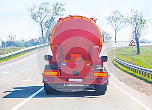 Gasoline tanker moves on a country road. Back view