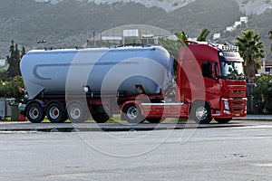 Gasoline tanker truck transporting lubricants parked by the road close-up