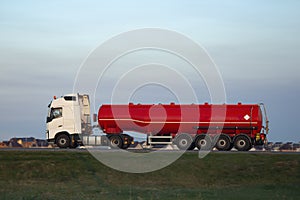 Gasoline truck Oil trailer on highway driving along the road. side view of Tank vehicle at work