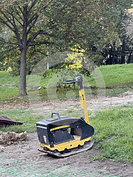 Gasoline vibratory plate compactor at a construction site