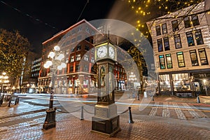 Gastown Steam Clock and Vancouver downtown beautiful street view at night.