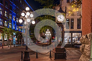 Gastown Steam Clock and Vancouver downtown beautiful street view at night.