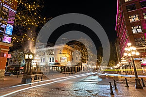 Gastown Steam Clock and Vancouver downtown beautiful street view at night.