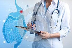 Gastroenterologist holding clipboard and virtual image of intestine on light background, closeup