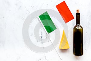Gastronomical tourism. Italian food symbols. Italian flag, cheese parmesan and bottle of red wine on white background