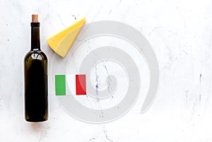 Gastronomical tourism. Italian food symbols. Italian flag, cheese parmesan and bottle of red wine on white background