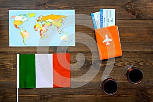 Gastronomical tourism. Italian food symbols. Passport and tickets near italian flag, glass of red wine, map of the world