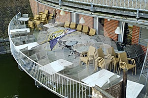 Gastronomy lockdown due to coronavirus, closed reataurant, cafe or bar outdoor terrace with stcked tables and chairs