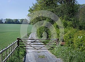 Gate across a gravel farm road.