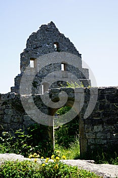 Gate and building facade grey stone castle ruin