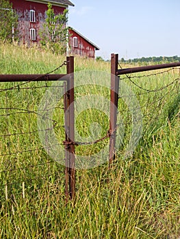 Gate entrance to farm with tall grass