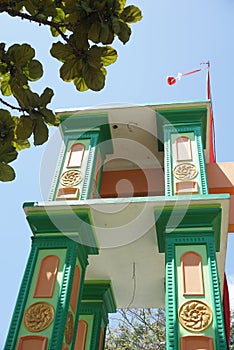 A gate at the entrance of a village has a red and white flag umbul umbul attached which is the Indonesian flag