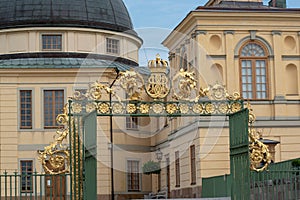 Gate with golden royal monogram at Drottningholm castle