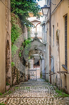 Gate on a narrow Spoleto street with a stone staircase