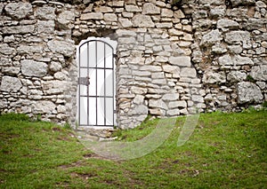 Gate in old stone castle wall, architectural detail