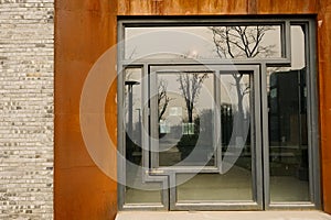 Gate with rusted steel doorframe in afternoon sunlight