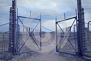 Gate to the concentration camp auschwitz-birkenau. Barbed wire fence around the death camp in Oswiecim.