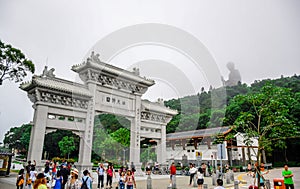 Gate to the Po Lin Monastery with Tian Tan Buddha statue up on the hill in Ngong Ping Village, Lantau Islan