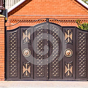 Gates of brown metal sheets. Roofing materials