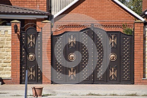 Gates of brown metal sheets. Roofing materials.