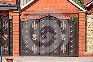 Gates of brown metal sheets. Roofing materials.