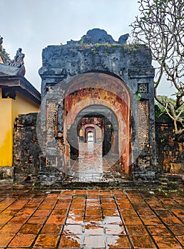 The gates gallery at Emperor Tu Duc Tomb a on a heavy rain day. Hue, Vietnam