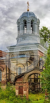 Gates and pillar-shape bell tower of large Orthodox Church of St. Nicholas the Partially destroyed large Orthodox Church