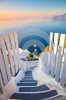 Gateway to rest. Santorini, Greece. Dawn of the sun, open doors and steps to the blue sea of Santorini island, Oia